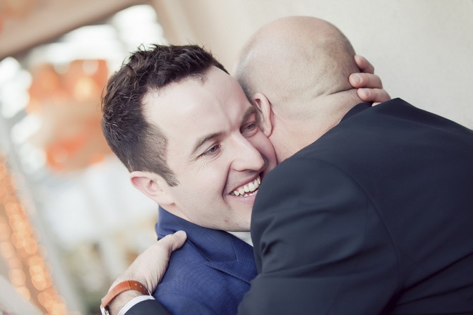 receiving line wedding groom huggin guest. real wedding by claire durkin photography groom hugging best man
