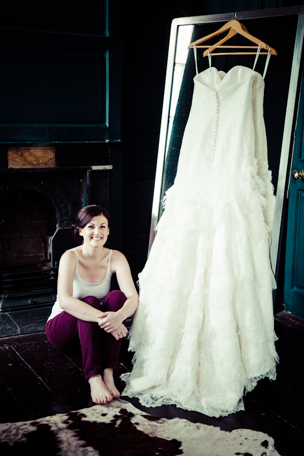 bride with dress hanging up