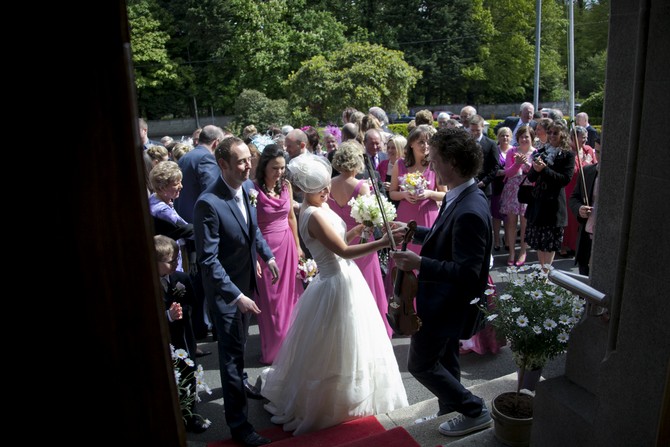 wedding party outside church weddingsonline.ie penry photography penry photography real wedding blog ireland
