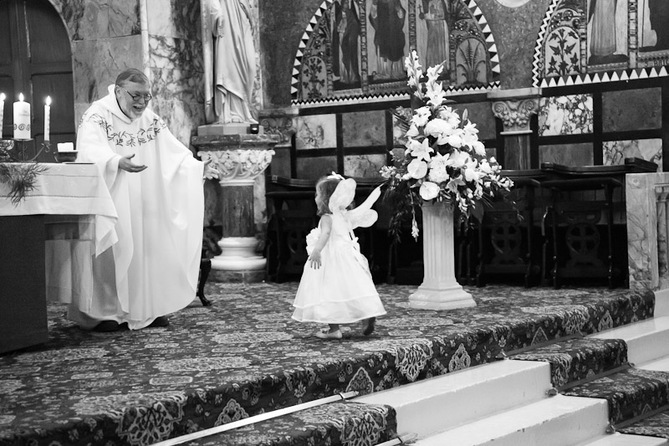 priest and flower girl wedding