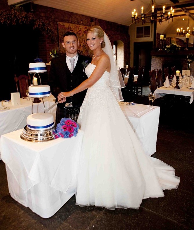 bride and groom cutting cake